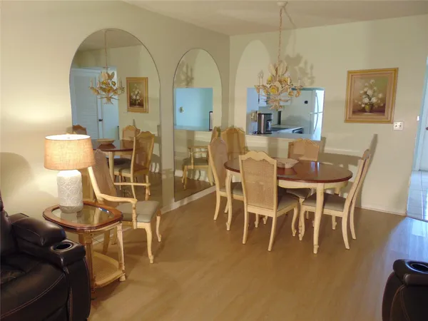 a dining room with furniture and wooden floor