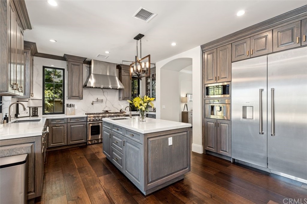 19 Alexa Lane Ladera Ranch, CA 92694 - Photo 34 of 40 a kitchen with kitchen island granite countertop a sink stove and refrigerator