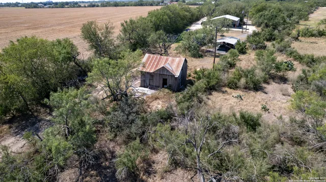 an aerial view of a house with a yard and lake view