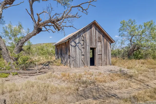 a view of a house with a tree in the background