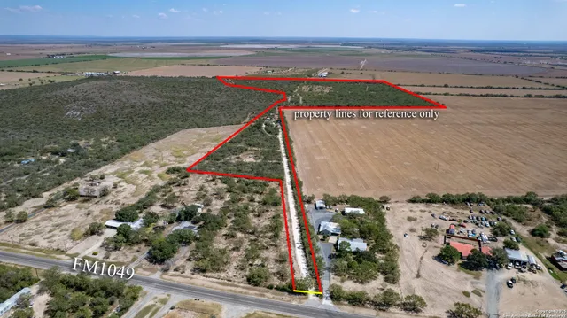 an aerial view of a house with a yard and lake view