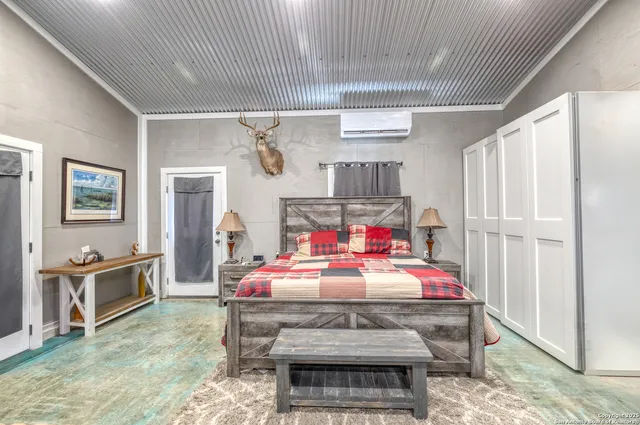 a bedroom with furniture and flat screen tv