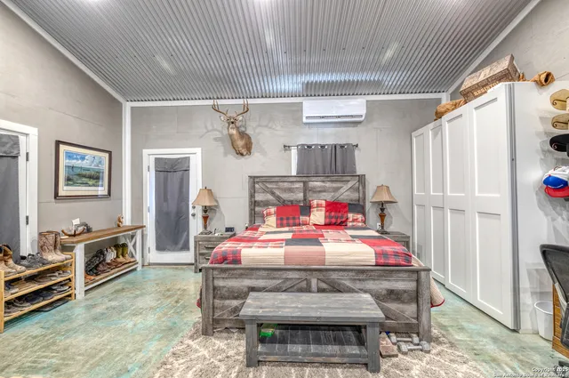 a bedroom with furniture and flat screen tv