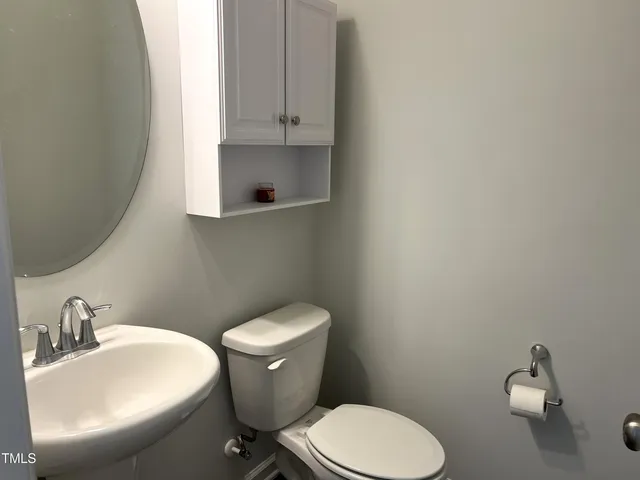 a white toilet sitting next to a bathroom sink