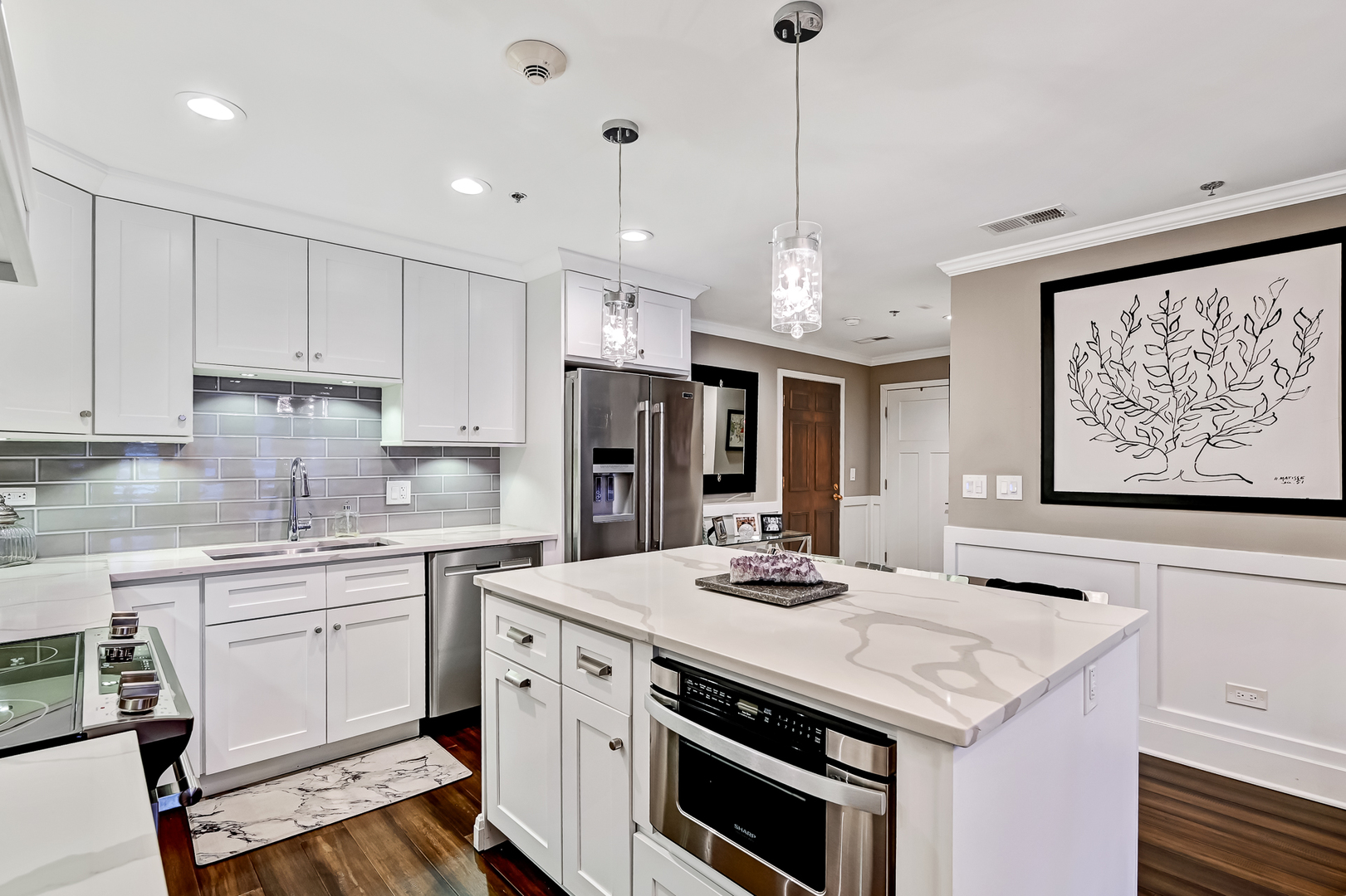 1140 Old Mill Road, Unit 101F Hinsdale, IL 60521 - Photo 5 of 14 a kitchen that has a sink a stove and chairs
