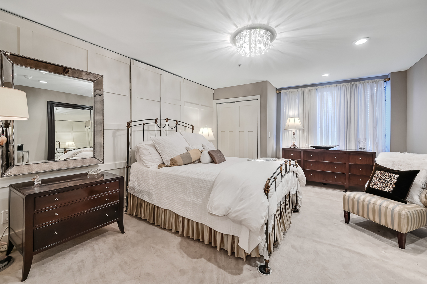 1140 Old Mill Road, Unit 101F Hinsdale, IL 60521 - Photo 10 of 14 a spacious bedroom with a bed and a chandelier