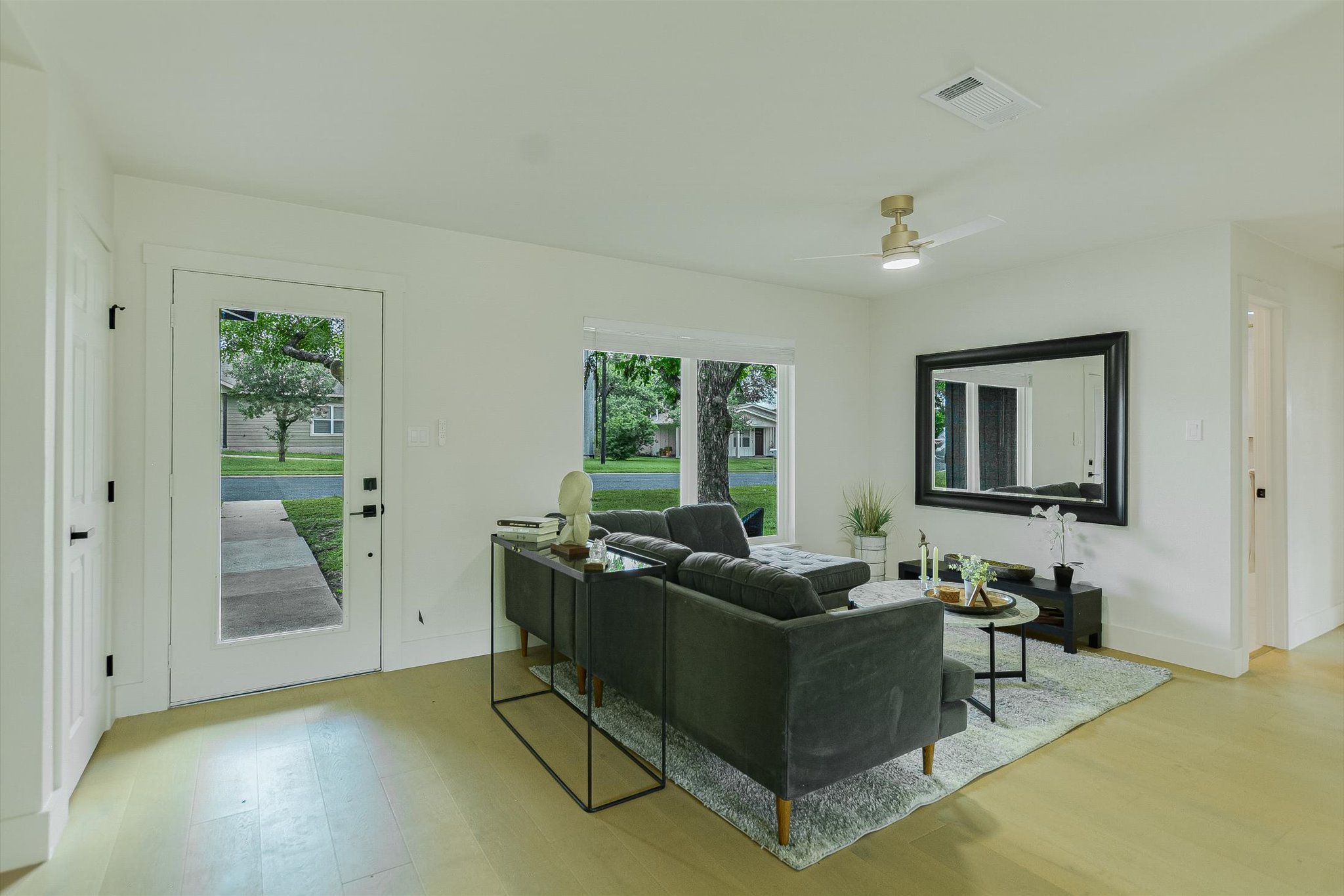 4505 Kitty Avenue Austin, TX 78721 - Photo 4 of 11 Blonde hardwood floors extend through this naturally illuminated living space, offering views of the inviting front yard.