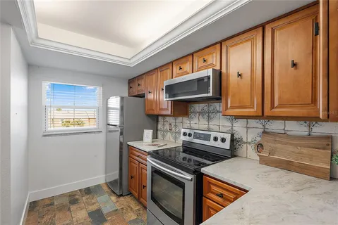 a kitchen with stainless steel appliances granite countertop a stove a sink and a microwave