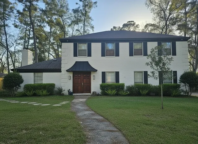 a front view of a house with garden