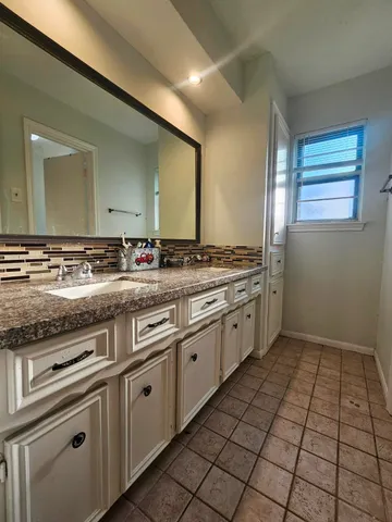 a kitchen with a stove sink and cabinets