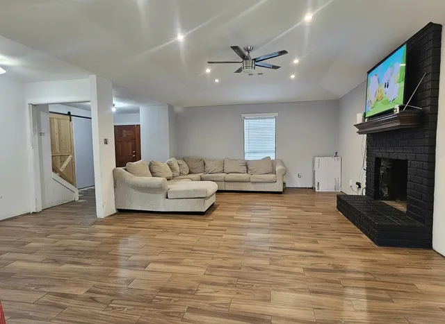 a living room with furniture flat screen tv and a fireplace