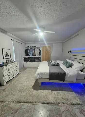 a bedroom with bed and window