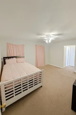 a bed sitting in a bedroom next to a window