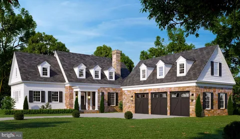 front view of a brick house with a yard