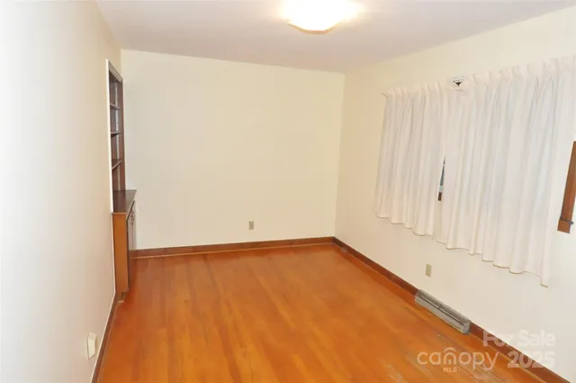 a view of wooden floor and brick wall