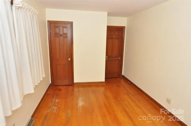 a room with window and dresser