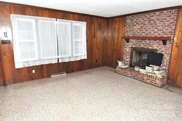 a view of an empty room with wooden walls