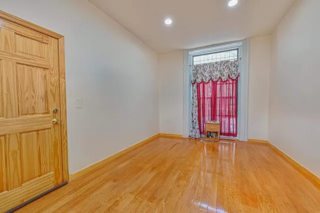 a view of a room with wooden floor and windows