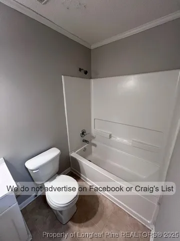 a bathroom with a toilet and a bathtub
