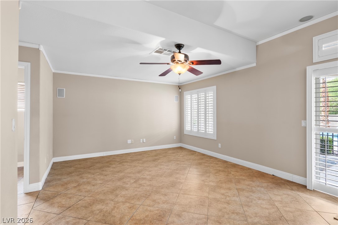 708 Vortex Avenue Henderson, NV 89002 - Photo 17 of 71 An inviting room with sleek tiled floors and elegant window shutters.
