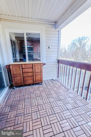 a view of a porch with wooden floor