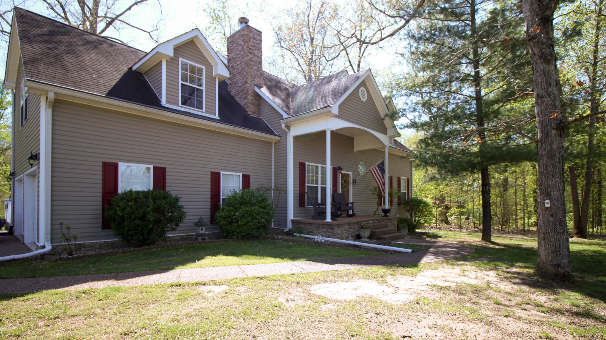 1783 Friendship Road Cross Plains, TN 37049 - Photo 2 of 24 a view of a brick house with large windows and a large tree