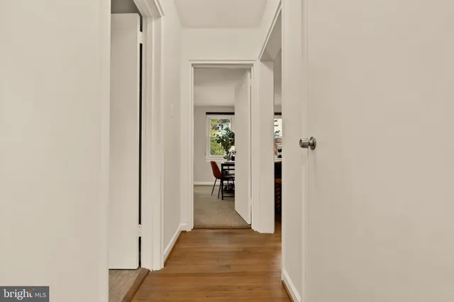 a view of a hallway with wooden shelves