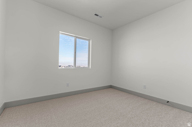 562 West Coyote Rdg Road Grantsville, UT 84029 - Photo 26 of 27 Bright room featuring a single window, light-colored carpeting, white walls, and gray baseboards