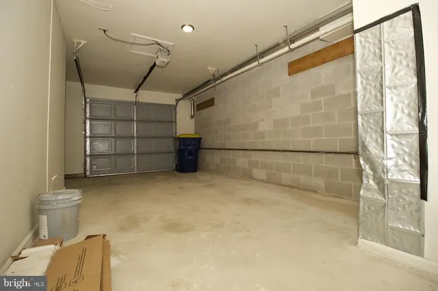 a kitchen with stainless steel appliances a sink a stove a refrigerator and cabinets