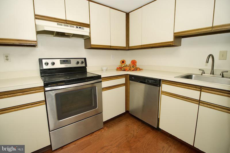 305 Pine Valley Road Dover, DE 19904 - Photo 18 of 37 a kitchen with white cabinets stainless steel appliances and sink