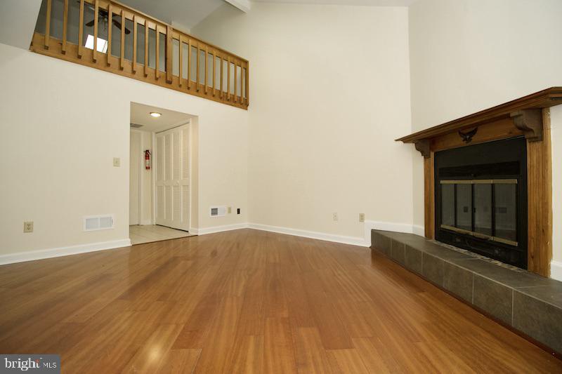 305 Pine Valley Road Dover, DE 19904 - Photo 20 of 37 a view of an empty room with wooden floor and a fireplace
