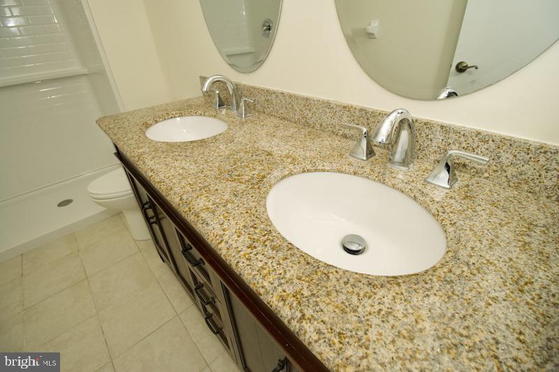 305 Pine Valley Road Dover, DE 19904 - Photo 26 of 37 a bathroom with a sink and mirror