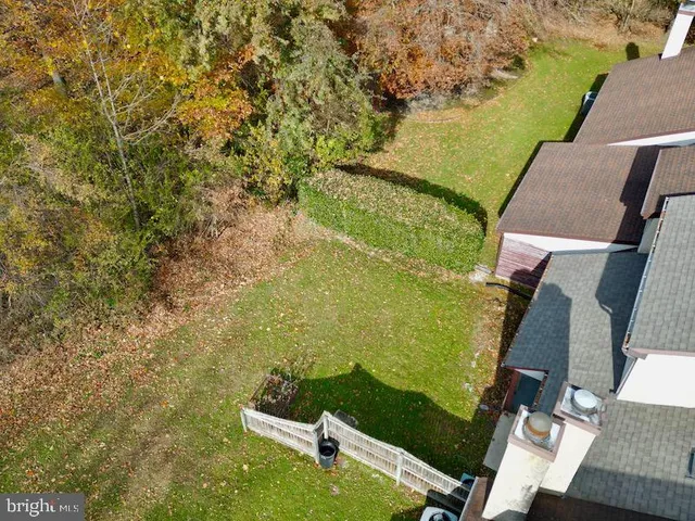 an aerial view of a residential houses with outdoor space