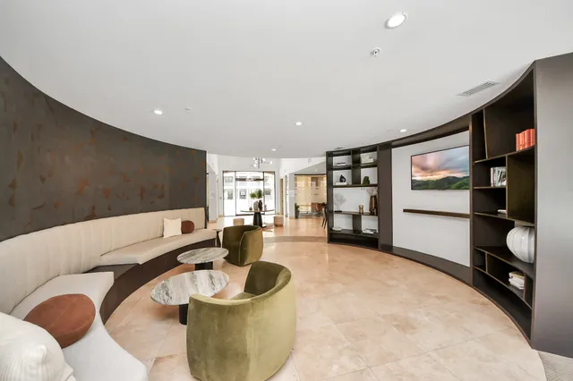 a kitchen with a couch and a large window