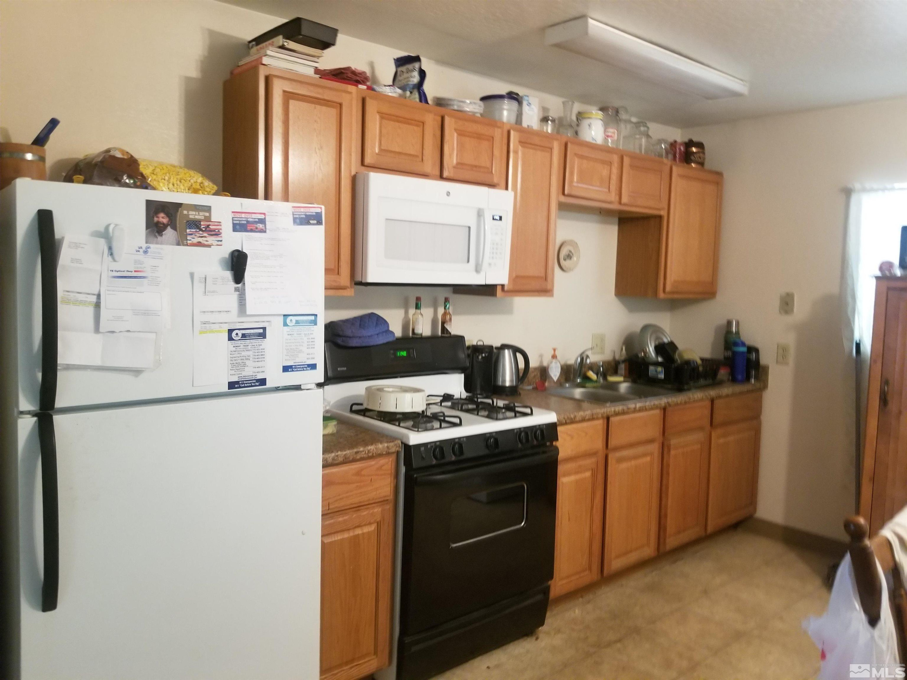 250-252 South Taylor Street Fallon, NV 89406 - Photo 12 of 29 a kitchen with stainless steel appliances granite countertop a sink stove and refrigerator
