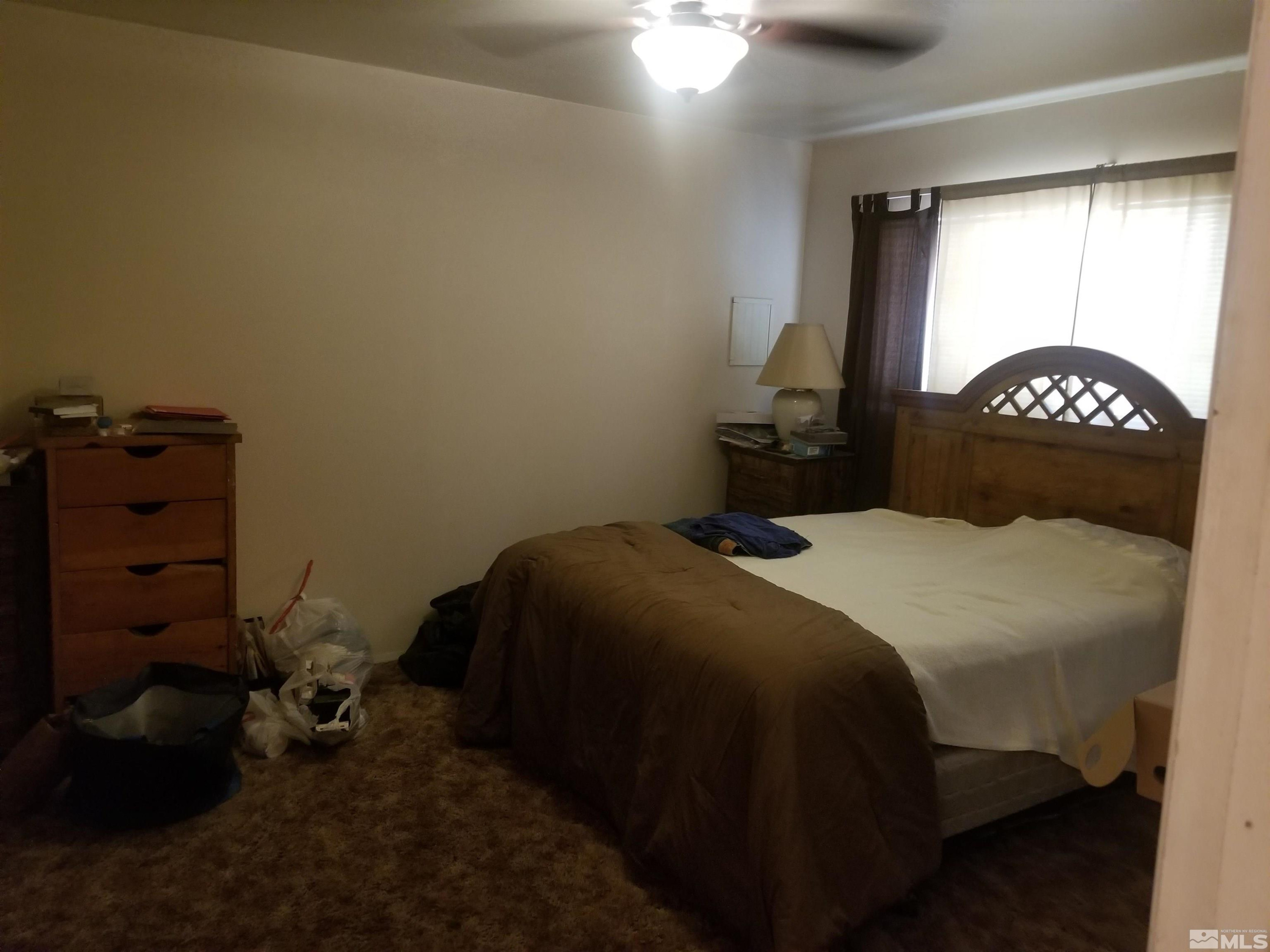 250-252 South Taylor Street Fallon, NV 89406 - Photo 16 of 29 a bedroom with a bed and a closet