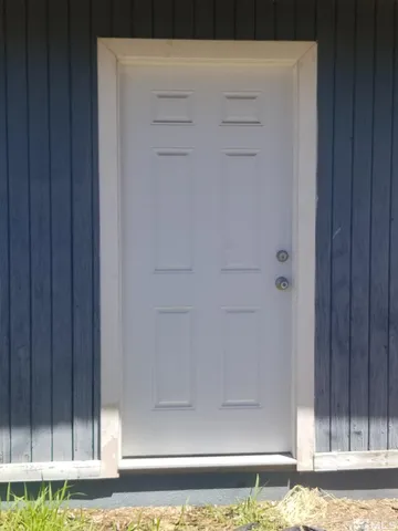 a view of a house with backyard porch and sitting area