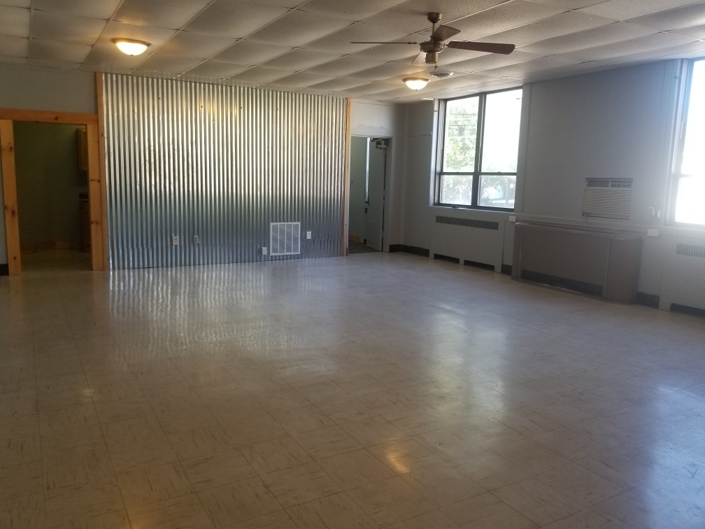 345 6th Street, Unit 301 LaSalle, IL 61301 - Photo 3 of 5 an empty room with wooden floor and windows