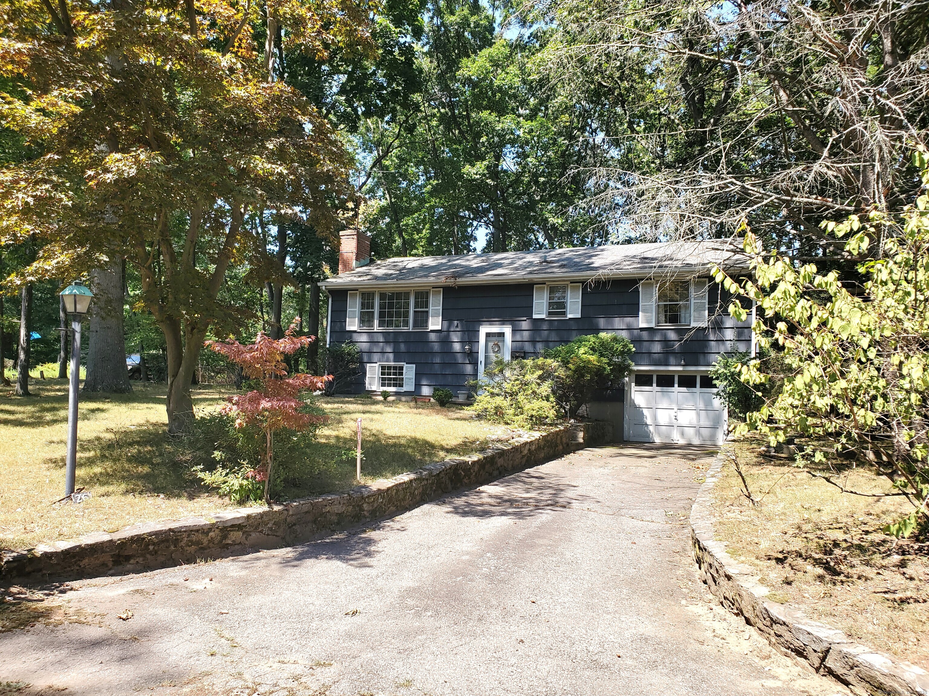 a view of a house with sitting area and garden