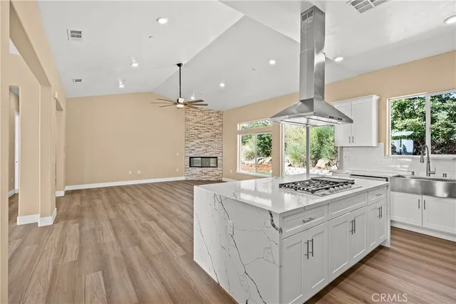 a kitchen with white cabinets and appliances