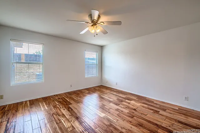 wooden floor in an empty room with a window