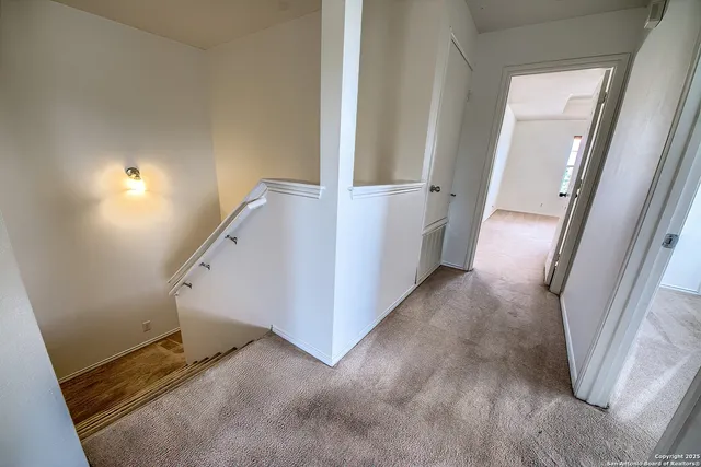 a view of a hallway view with staircase