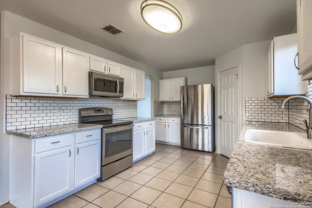 a kitchen with a sink stove and refrigerator