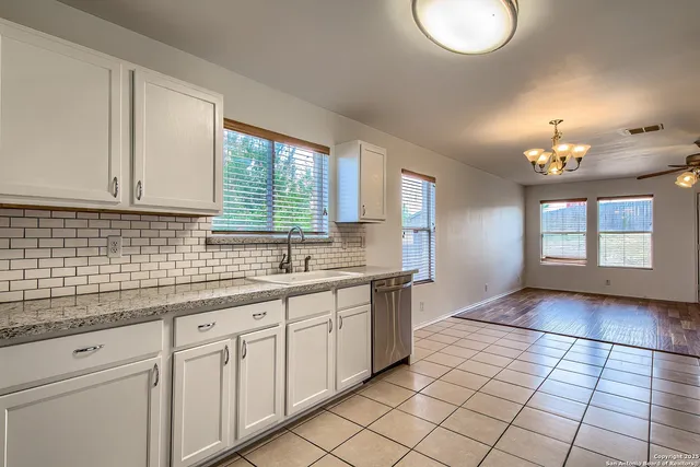 a kitchen with a sink cabinets and window