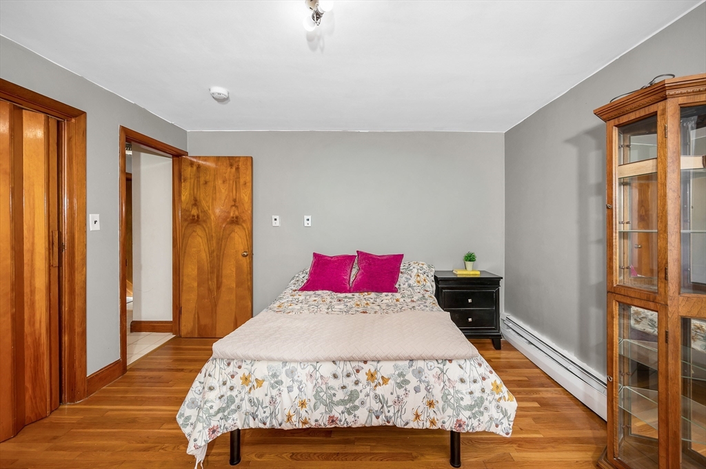 7 Marie Street Methuen, MA 01844 - Photo 14 of 39 a bed sitting in a bedroom next to a window