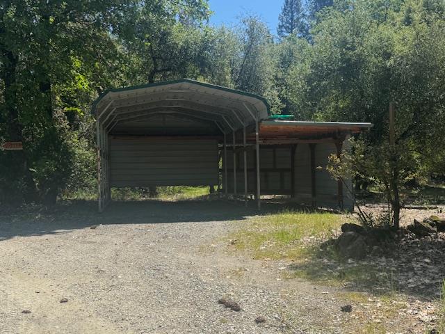 12767 Newtown Road Nevada City, CA 95959 - Photo 42 of 57 a front view of a house with a yard and garage