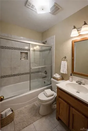 a bathroom with a granite countertop toilet sink and shower