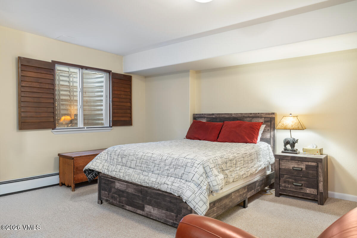 288 Edwards Village Boulevard, Unit 6A Edwards, CO 81632 - Photo 27 of 36 a bedroom with a bed and a window