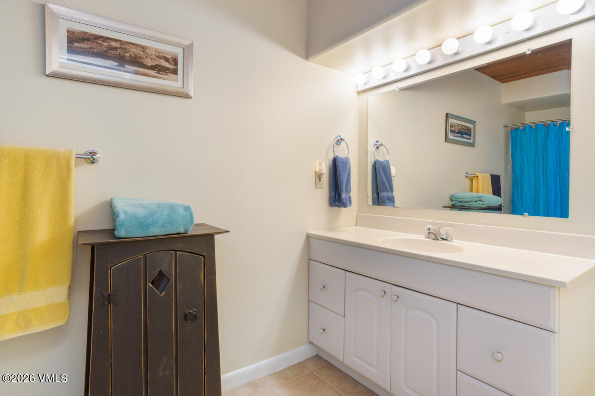 288 Edwards Village Boulevard, Unit 6A Edwards, CO 81632 - Photo 28 of 36 a bathroom with a sink and a mirror