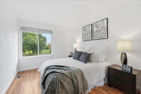 a bedroom with a bed and a window